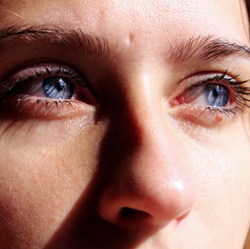 close up of thoughtful young woman with blue eyes