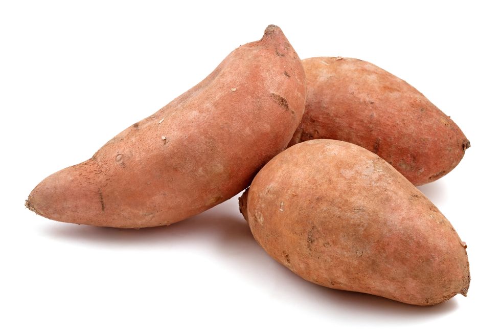 close up of three raw sweet potatoes