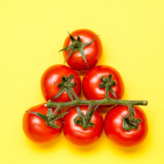 Close-Up Of Tomatoes Against Yellow Background