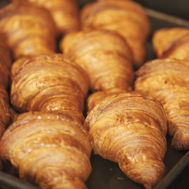 close up of tray of freshly baked croissants in a bakery