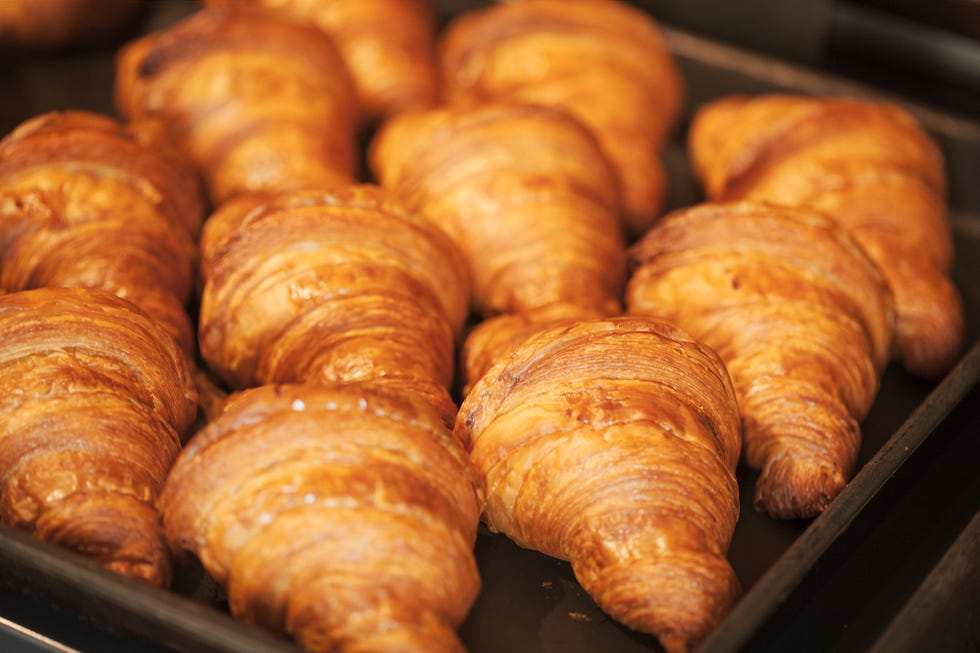 close up of tray of freshly baked croissants in a bakery