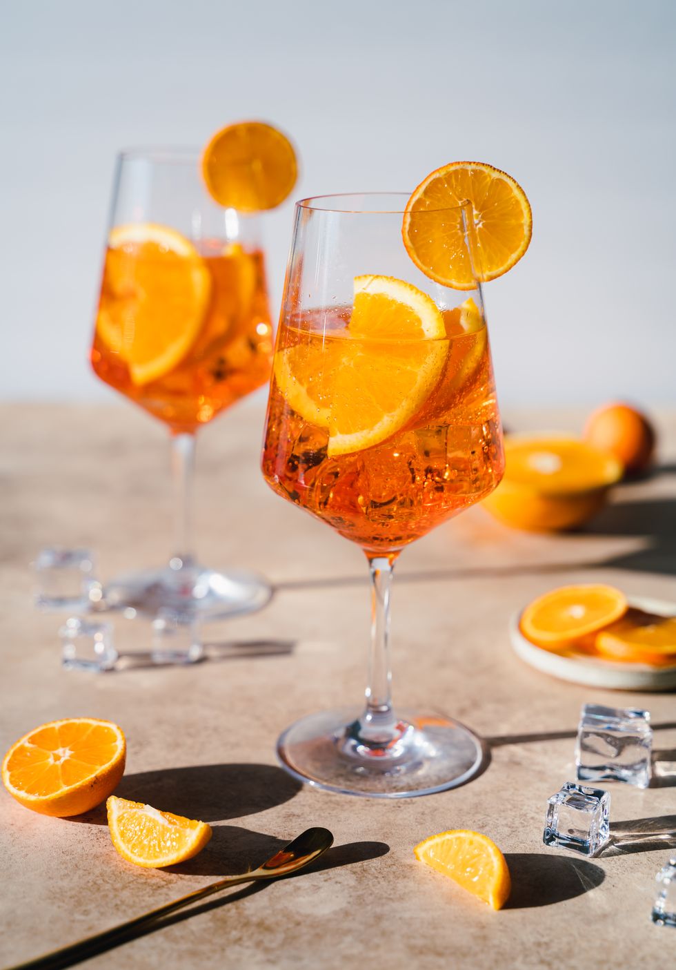 close up of two spritz drinks on sunny beige background