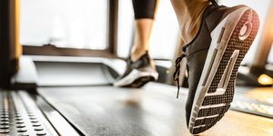 close up of unrecognizable athlete running on a treadmill in a gym