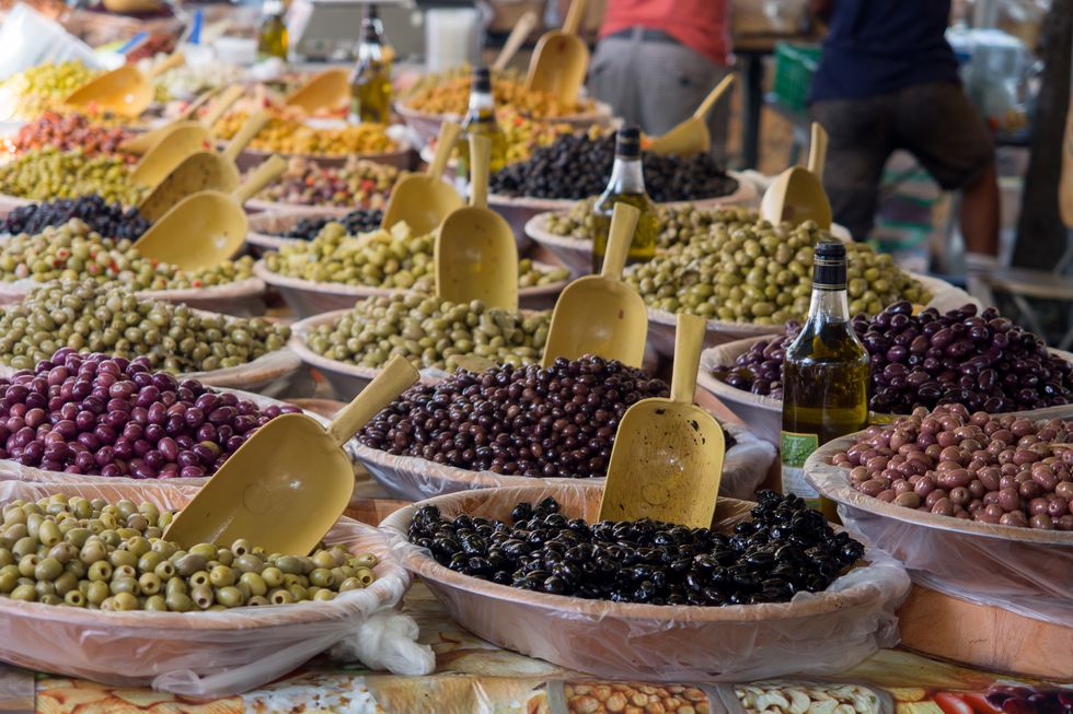 various olives for sale at market stall