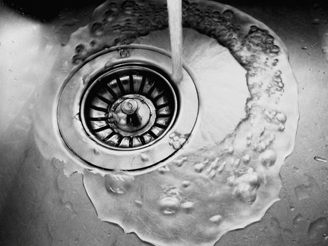 Close-Up Of Water Running On Sink