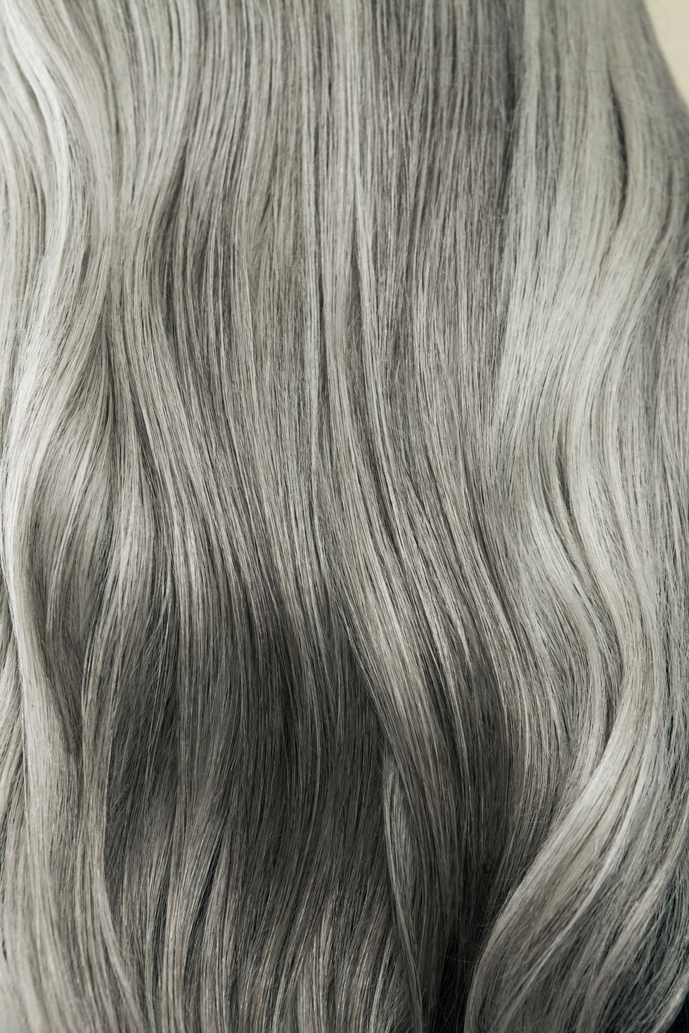 close up of wavy, long, silver gray hair