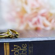 bible verses about marriage two wedding bands resting on top of the holy bible