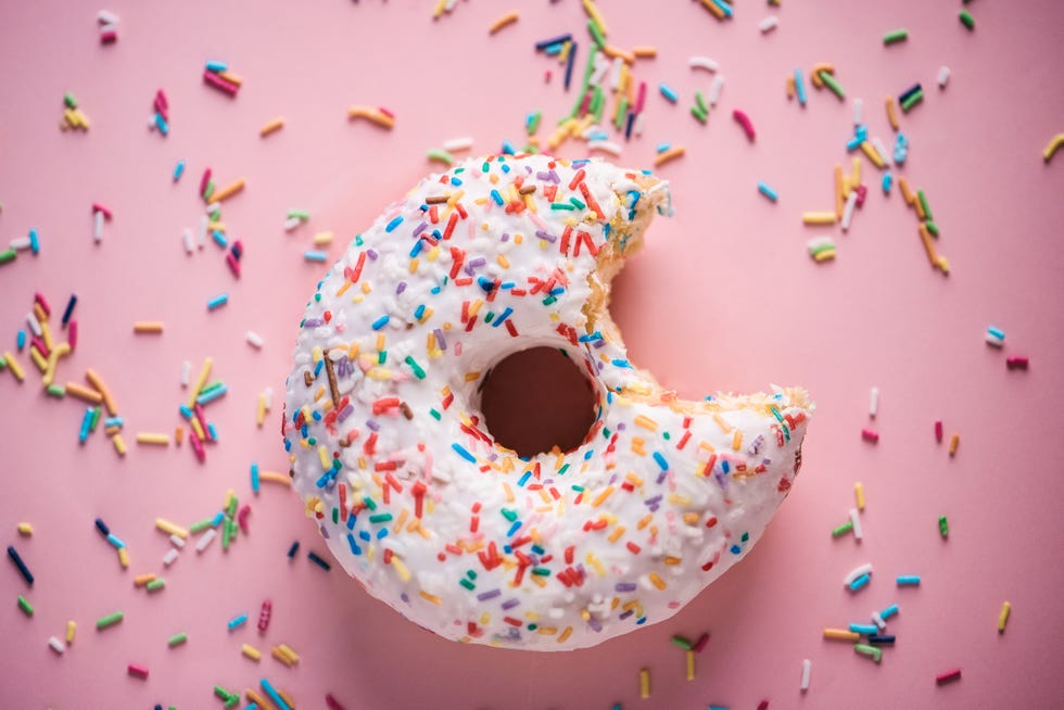 close up of white donuts with multi colored sparks