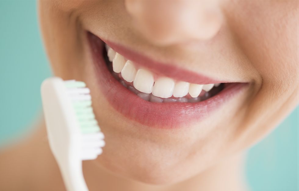 close up of woman brushing teeth