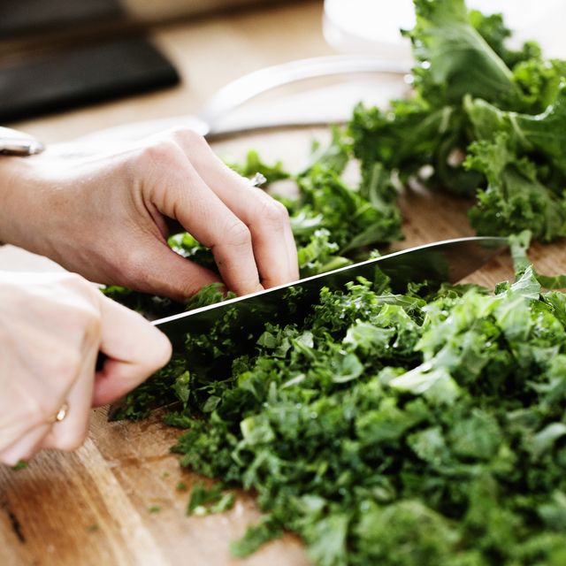 close up of woman chopping vegetables