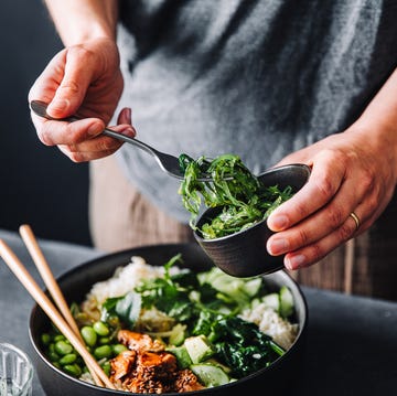 Close-up of woman eating omega 3 rich salad close up of woman eating omega 3 rich salad