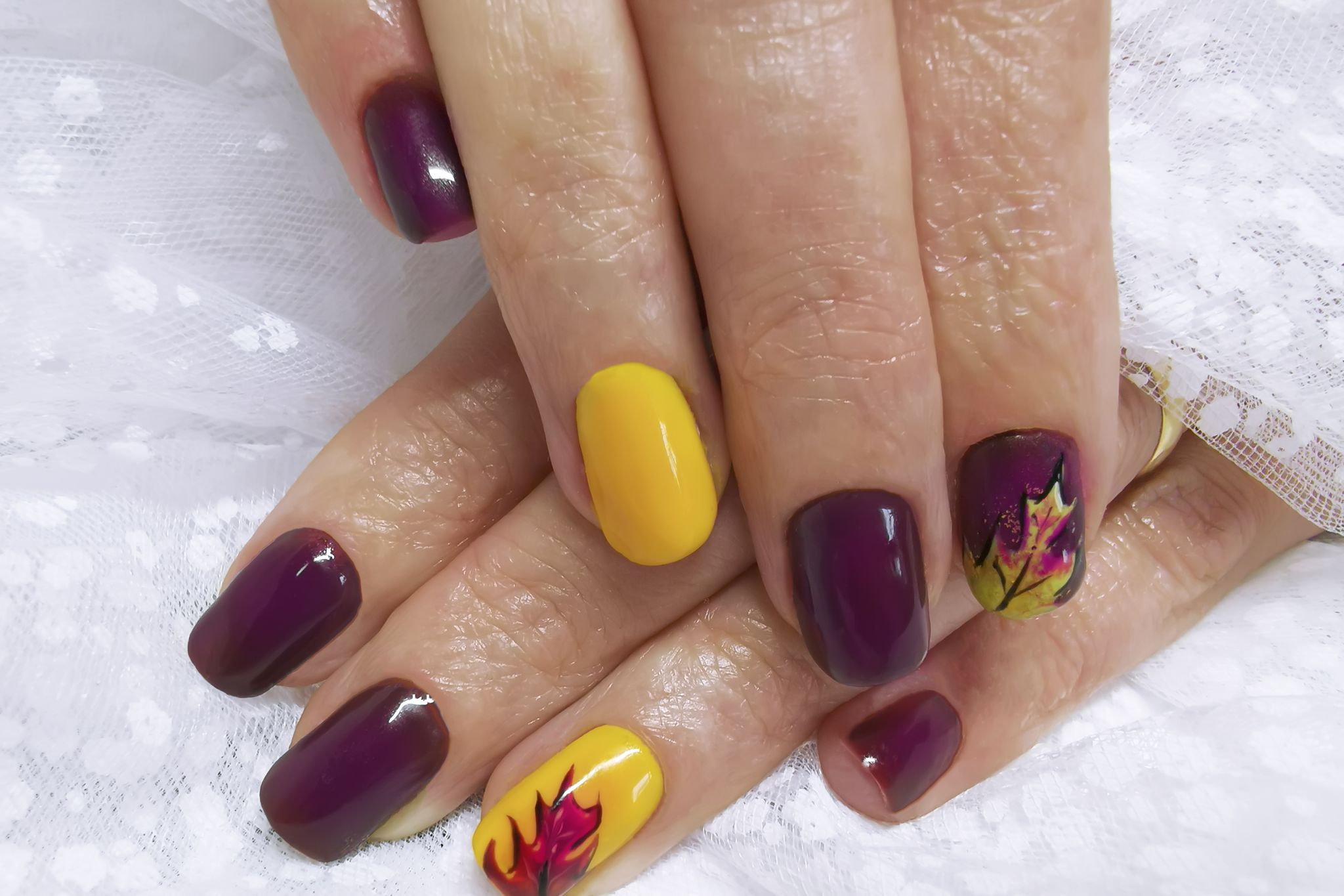 close up of woman fingers with nail art, autumn inspired nail designs