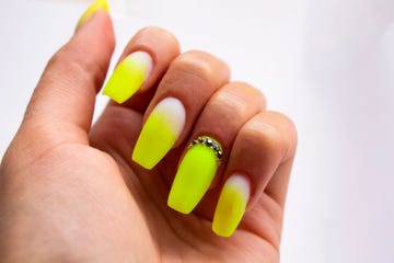 Close-Up Of Woman Fingers With Nail Art Manicure with Neon Green Colour