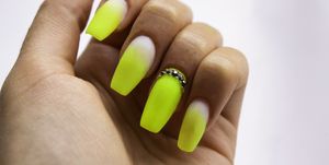 Close-Up Of Woman Fingers With Nail Art Manicure with Neon Green Colour