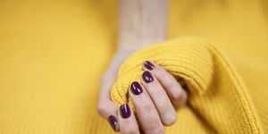 Close-Up Of Woman Fingers With Nail Art. Maroon nail polish