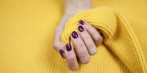 Close-Up Of Woman Fingers With Nail Art. Maroon nail polish