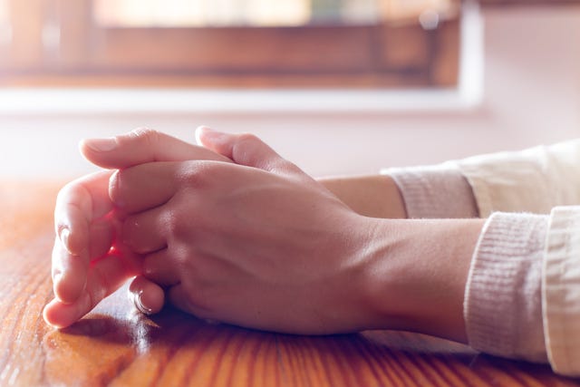 Close-up of woman hands in reflexive and concern position