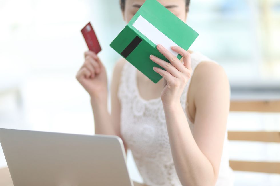 Close up of woman holding bank book and credit card