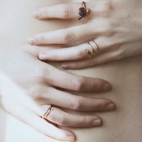 close up of woman holding hands on her stomach