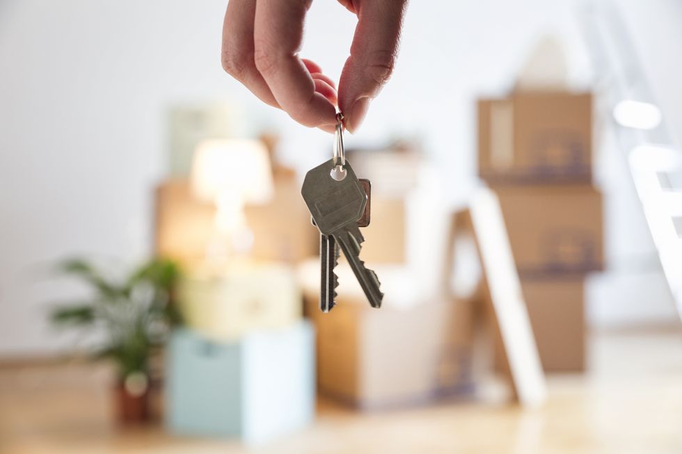 closeup of woman holding house key in new home