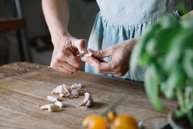 Close-up of woman peeling garlic