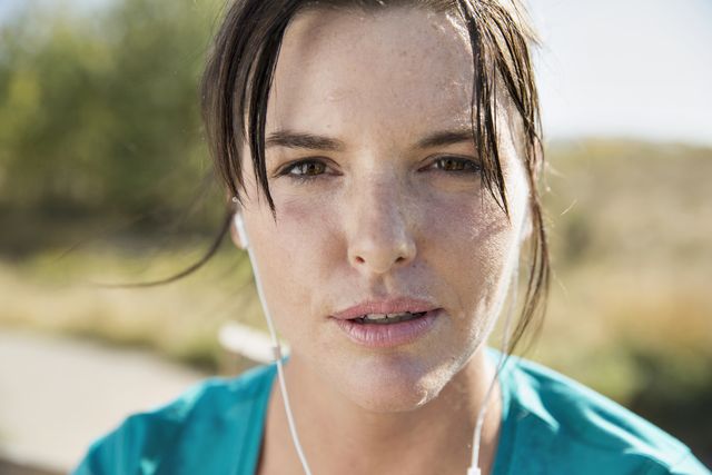 Close-up of woman sweating during outdoor workout.