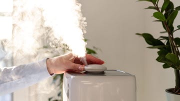 close up of woman using humidifier at home