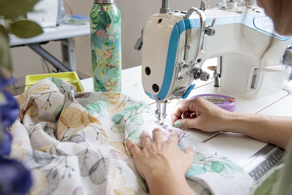 woman using sewing machine