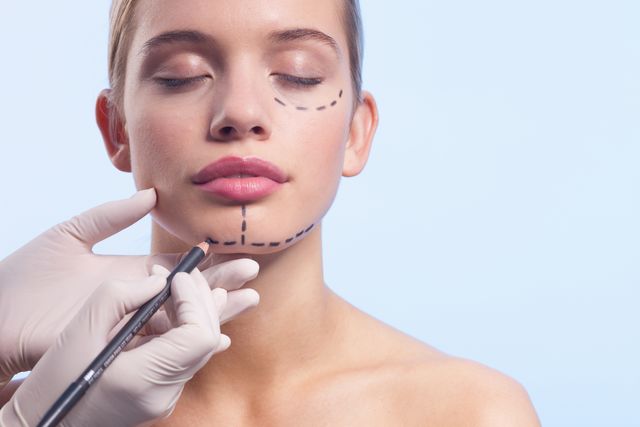 close up of womans face being marked with dotted lines