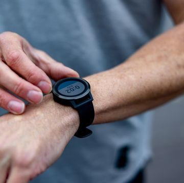 close up on male runner setting up his smart watch