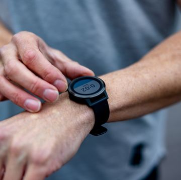 close up on male runner setting up his smart watch