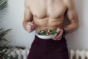 close up photo of man holding fresh salad