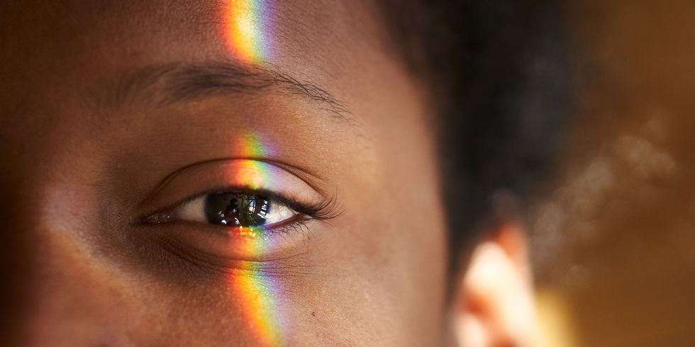 close up photo of multi coloured light falling on human eye