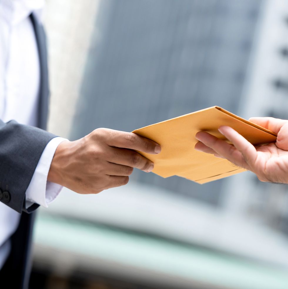 close up portrait of  businessman hand recieving yellow envelope