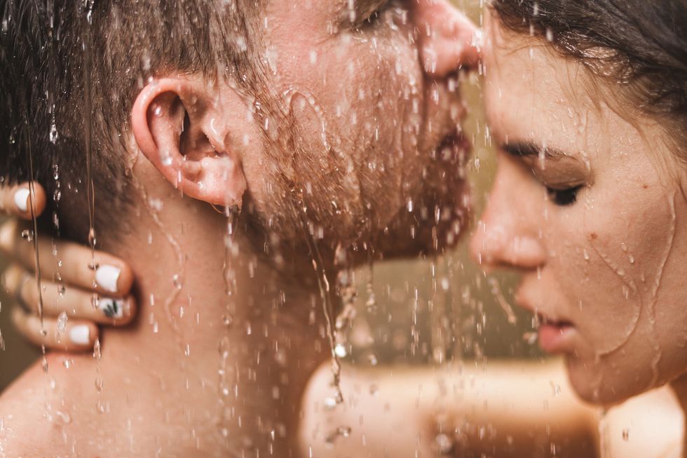 close up portrait of couple in love kissing under tropical shower with passion intimate, togetherness and romantic