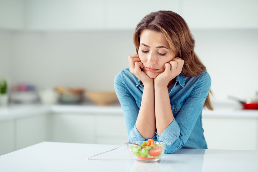 close up portrait of her she nice lovely charming attractive sad bored dull disappointed brown haired lady looking at new green detox vitamin salad in light white interior style kitchen
