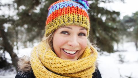 Close up portrait of woman in wooly hat and scarf in winter