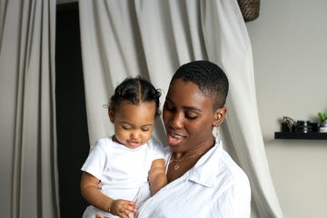 close up portrait of young mother holding baby daughter