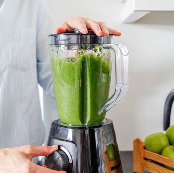 a close up shot of the blender while making a smoothie