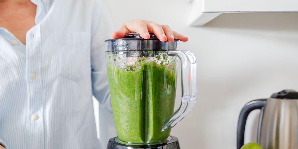 a close up shot of the blender while making a smoothie