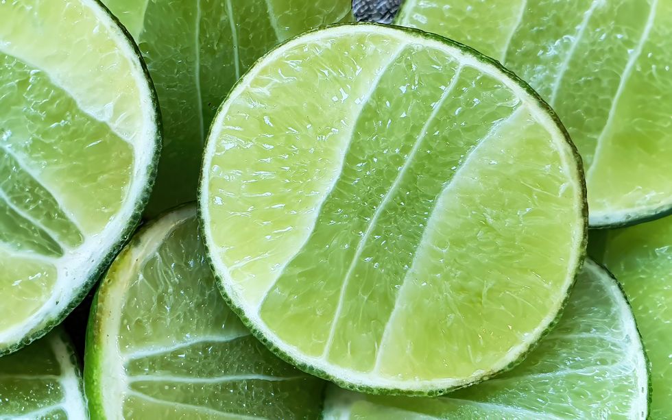 close up sliced of lime wedge, citrus sour fruit, fresh natural vitamin c, healthy diet, vegan, macro shot for food background or wallpaper
