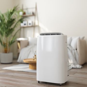 close up view of portable air conditioner with blurred living room background