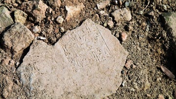 close up view to plate with cuneiform sumerian text at the ruins of processional street of ancient babylon, hillah, iraq