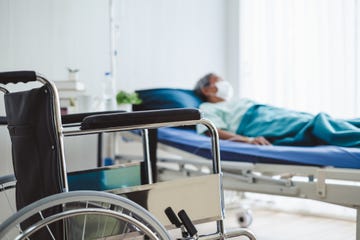 close up wheelchair over disabled old patient with mask at hospital