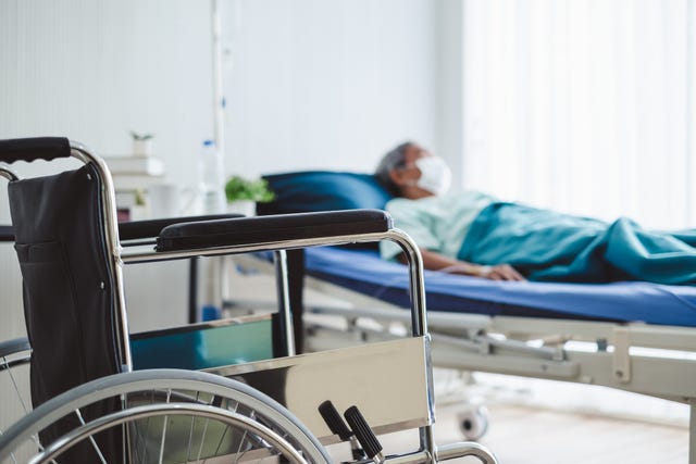 close up wheelchair over disabled old patient with mask at hospital