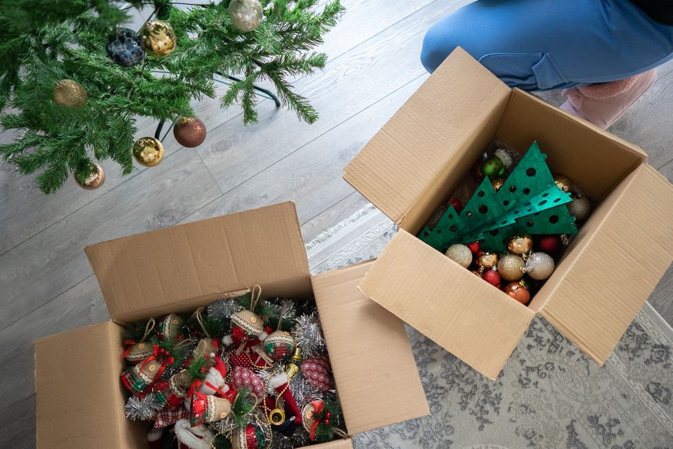 close up woman picking up christmas decorating at home