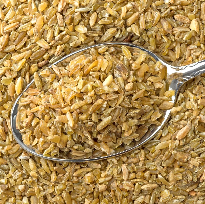 Close view of cracked freekeh grain with spoon