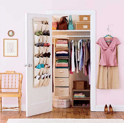 closet organization ideas, open closet with a over the door shoe rack, closet with clothes and a rolling cart full of shoes