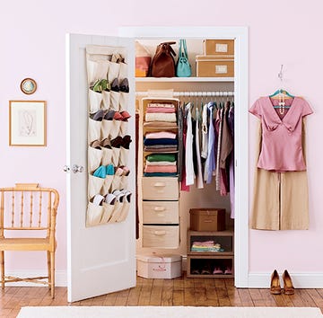 closet organization ideas, open closet with a over the door shoe rack, closet with clothes and a rolling cart full of shoes