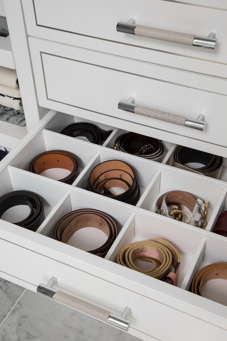 An idea to organize your closet by putting belts in white drawers